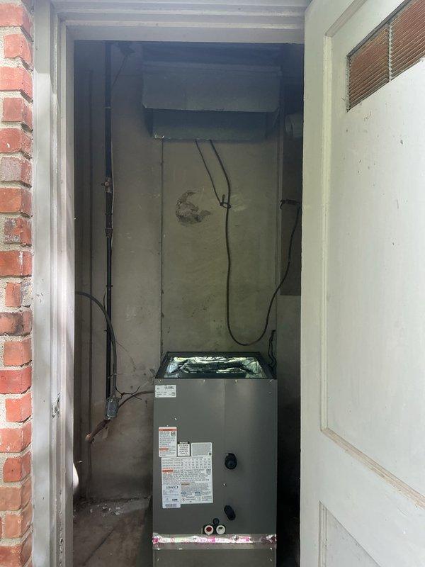 Completed full installation of 3.5-ton A/C system with evaporator coil and 2000 media cabinet in interior utility closet. Air handler unit positioned and secured on concrete floor with electrical conduit run and connected, condensate drain line installed, and all manufacturer specifications verified. System wired per code requirements with mechanical and electrical permits requested, unit tested for proper operation, and rear discharge configuration confirmed with all connections remeasured for accuracy.