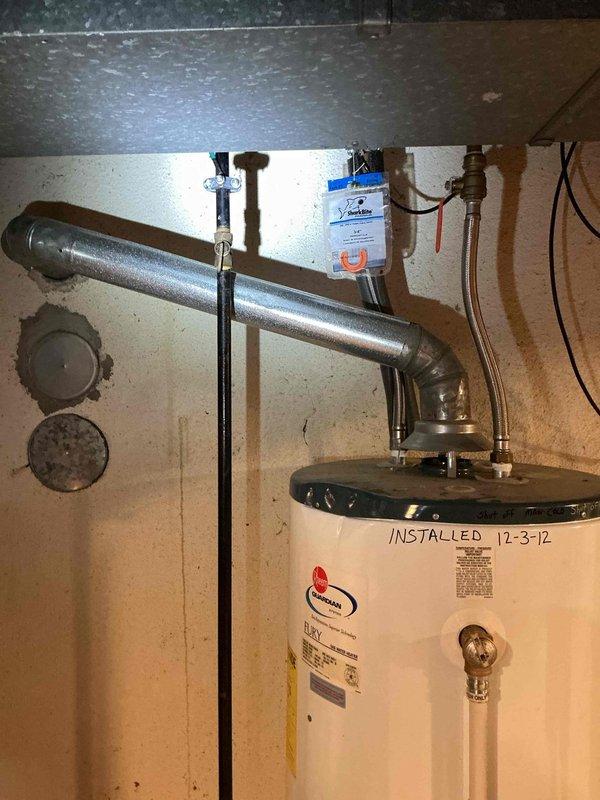 Performed follow-up inspection on approximately 14-year-old Rheem water heater installation originally installed in December 2012. Identified and documented non-compliant gas valve and non-compliant flexible gas supply lines that do not meet current safety codes and standards. Inspection conducted as coordinated follow-up to previous HVAC technician visit to ensure comprehensive assessment of gas system components and compliance issues.