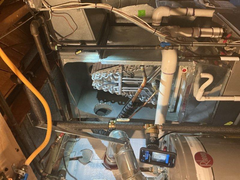 Responded to no-cooling complaint on 2-year-old basement air conditioning system. Upon inspection, diagnosed failed evaporator coil requiring replacement under warranty. Documented detailed photos of installation and surrounding area, noting active home renovation in progress. Ordered replacement evaporator coil from Lennox with expected delivery to warehouse, and coordinated with customer service regarding installation timeline once part arrives.