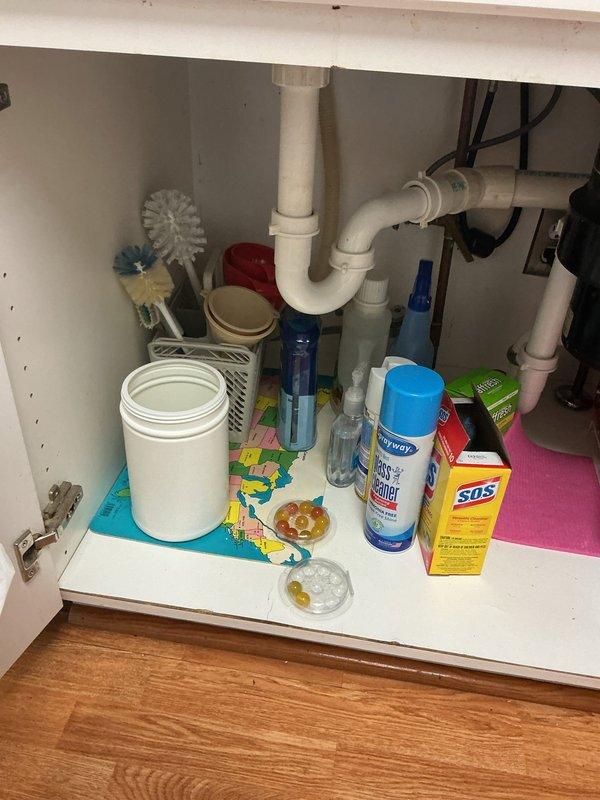 Responded to service call for multiple drain cleaning and kitchen faucet replacement. Successfully cleared 3-4 clogged drains throughout the residence to restore proper drainage flow. Removed existing kitchen faucet and installed new brushed nickel pull-down faucet unit at double-basin stainless steel sink. Inspected under-sink plumbing connections, including PVC P-trap configuration, to ensure proper operation and verify no leaks present. Tested all cleared drains and new faucet installation for proper function before completing service.