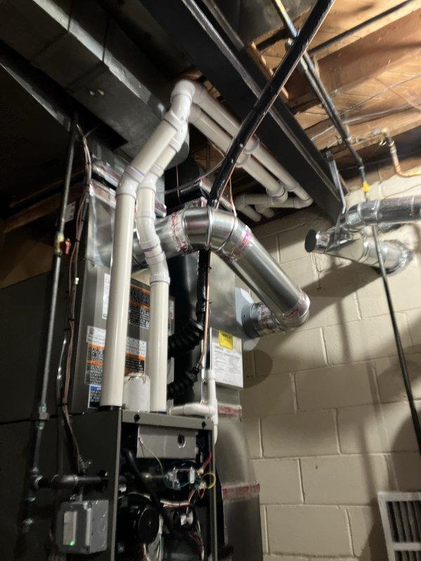 Completed full HVAC system installation including a 70,000 BTU furnace, 2-ton air conditioning unit with rear discharge configuration, humidifier, and Sensi programmable WiFi thermostat. Installed all necessary venting and drainage piping, connected ductwork to existing distribution system, and performed electrical reconnection. Mechanical and electrical permits were obtained prior to installation. System was commissioned, tested for proper operation, and qualified for utility rebate program.