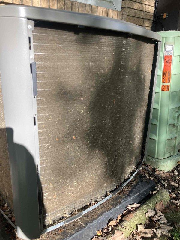Responded to no-cool complaint on 1-year-old air conditioning system at office location. Upon arrival, confirmed outdoor condenser unit was not engaging when thermostat called for cooling, though wall control showed proper mode switching with audible click. 

Performed visual inspection of outdoor unit and discovered heavily soiled condenser coil with significant dirt, dust, and debris accumulation restricting airflow. Found additional organic debris including leaves and twigs collected at base of unit. Indoor air filter also showed loading with dust and particles.

Cleaned condenser coil thoroughly to restore proper airflow and heat transfer capability. Removed all debris from base of outdoor unit. Replaced indoor air filter with clean filter. Cycled system through cooling mode and verified outdoor condenser now engages properly when thermostat calls for cooling. Confirmed adequate airflow across coil and normal system operation. Unit cooling effectively with no further issues observe