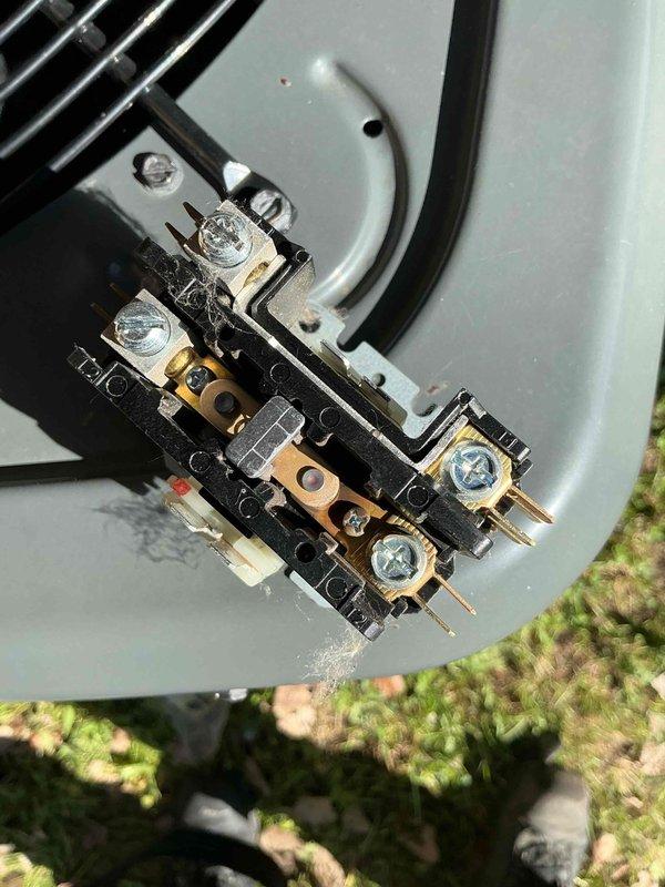 Responded to service call for 3-year-old Goodman air conditioning unit with reduced cooling capacity and ice buildup on outdoor coil and refrigerant lines. Upon inspection, found heavily soiled electrical panel with significant dust, debris, and cobweb accumulation affecting system performance. Cleaned electrical connections and terminal block assembly, removed accumulated dirt from contactor housing, and inspected wiring connections for proper operation. Verified electrical components functioning correctly after cleaning, checked refrigerant line connections, and confirmed system returned to normal cooling operation with ice buildup resolved.