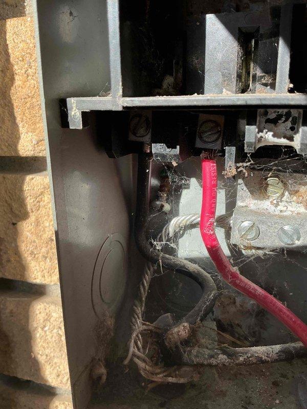 Responded to service call for 3-year-old Goodman air conditioning unit with reduced cooling capacity and ice buildup on outdoor coil and refrigerant lines. Upon inspection, found heavily soiled electrical panel with significant dust, debris, and cobweb accumulation affecting system performance. Cleaned electrical connections and terminal block assembly, removed accumulated dirt from contactor housing, and inspected wiring connections for proper operation. Verified electrical components functioning correctly after cleaning, checked refrigerant line connections, and confirmed system returned to normal cooling operation with ice buildup resolved.