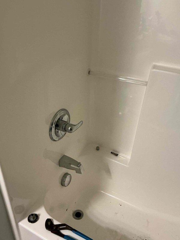 Responded to first-floor bathtub drainage issue and malfunctioning shower diverter control. Upon inspection, found tub drain slow due to debris accumulation in the drain assembly. Removed and cleaned drain stopper mechanism, clearing hair and organic matter from the drain opening. Tested drainage flow and confirmed proper operation. Examined shower diverter valve and found internal components corroded and binding, preventing proper switching between tub spout and showerhead. Serviced diverter mechanism, applying appropriate lubricant to restore smooth operation. Cycled diverter multiple times to verify full range of motion and proper function. Both fixtures now operating as intended with no leaks observed at any connection points.