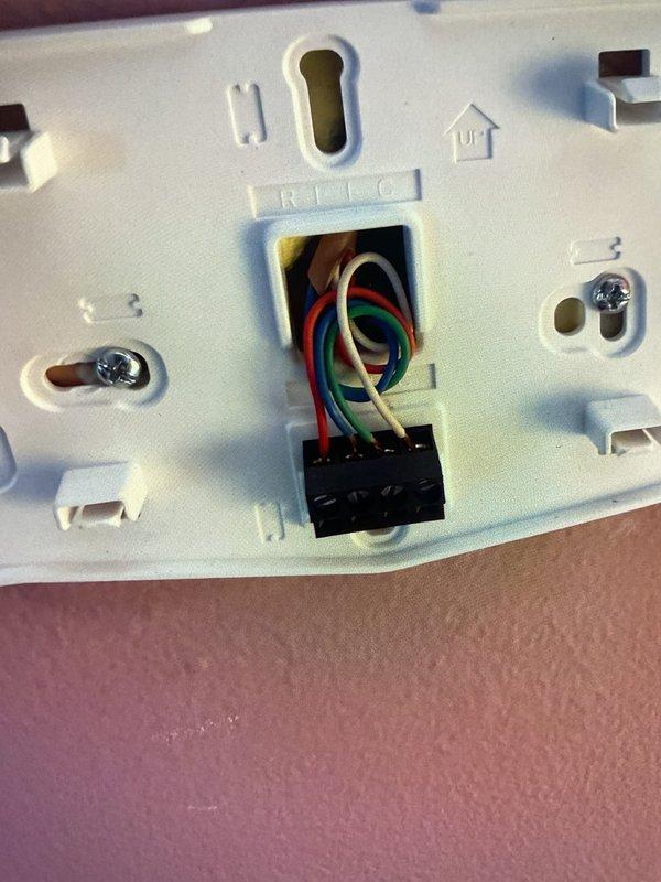 Responded to no-power condition on wall-mounted thermostat installed August 2023. Upon arrival, confirmed thermostat display was completely blank with no functionality. Removed thermostat from wall plate and inspected low-voltage wiring connections at terminal block, verifying proper wire terminations for R, C, Y, G, W, and common wires. Traced wiring back to HVAC equipment and verified 24V transformer output and circuit continuity. Determined thermostat unit had failed internally despite recent installation. Removed defective thermostat, installed replacement unit, reconnected all low-voltage wiring to appropriate terminals, and restored power. Tested thermostat operation through multiple heating and cooling cycles to confirm proper communication with HVAC system. Verified display functionality, temperature readings, and system response. Unit operating normally at time of departure.