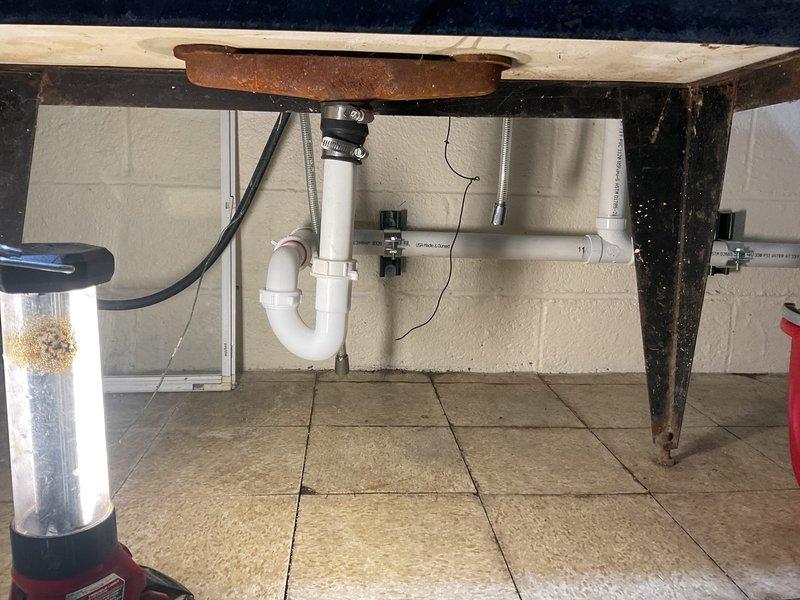 Completed comprehensive plumbing repairs including replacement of both exterior hose spigots with frost-free units and upgraded existing lead gate valves to ball valves on 1/2" copper lines. Rebuilt upstairs Delta two-handle lavatory faucet by installing new cartridges, seats, and springs per customer's preference for repair versus replacement. Reconfigured utility sink drain line by replacing 1.5" Fernco connection with 1.25" Fernco to accommodate tubular drain installation instead of PVC. Cut existing galvanized drain line above cleanout and adapted to new PVC drainage system with proper AAV installation and new bag trap for improved functionality and code compliance.