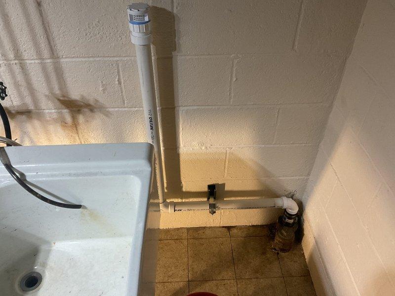 Completed comprehensive plumbing repairs including replacement of both exterior hose spigots with frost-free units and upgraded existing lead gate valves to ball valves on 1/2" copper lines. Rebuilt upstairs Delta two-handle lavatory faucet by installing new cartridges, seats, and springs per customer's preference for repair versus replacement. Reconfigured utility sink drain line by replacing 1.5" Fernco connection with 1.25" Fernco to accommodate tubular drain installation instead of PVC. Cut existing galvanized drain line above cleanout and adapted to new PVC drainage system with proper AAV installation and new bag trap for improved functionality and code compliance.