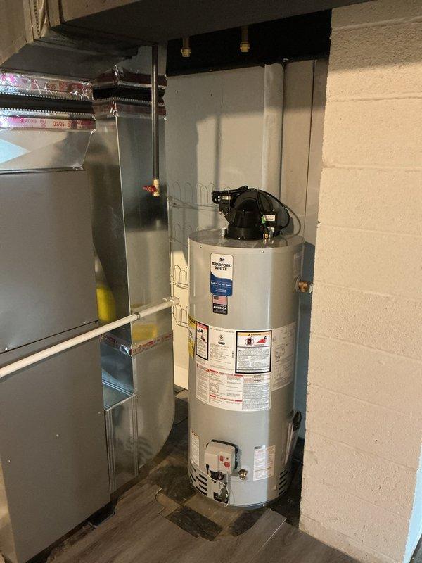 Completed comprehensive re-piping service in residential property, including installation of new shower valve, utility sink, and associated plumbing connections. Work was performed under service financing agreement with all documentation properly executed and identification verified on file. Protected work areas with appropriate floor coverings during installation process to maintain cleanliness in basement utility space where water heater and HVAC equipment are located.