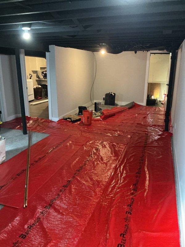 Completed comprehensive re-piping service in residential property, including installation of new shower valve, utility sink, and associated plumbing connections. Work was performed under service financing agreement with all documentation properly executed and identification verified on file. Protected work areas with appropriate floor coverings during installation process to maintain cleanliness in basement utility space where water heater and HVAC equipment are located.
