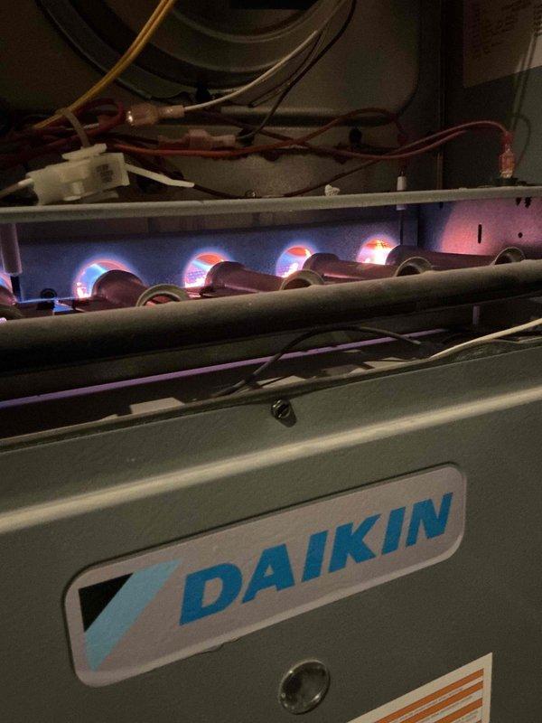Completed comprehensive Gold-level fall maintenance inspection on a 7-year-old Daikin gas furnace located in basement. Performed full system evaluation including visual inspection of heat exchanger, burner assembly, and all mechanical components. Verified proper ignition sequence and observed clean blue flame pattern with minimal orange tipping, indicating efficient combustion. Inspected blower motor assembly, electrical connections, and wiring harnesses for signs of wear or damage. Checked refrigerant lines, condensate drainage system, and all safety controls for proper operation. All components found to be functioning within manufacturer specifications. Unit is operating efficiently and ready for heating season.