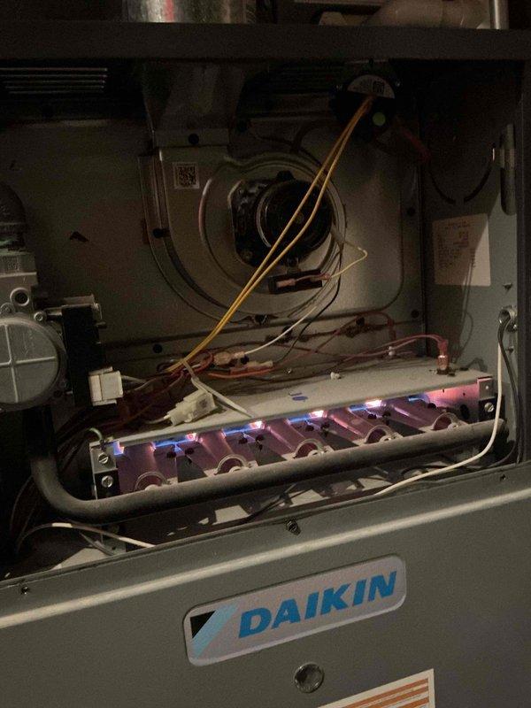 Completed comprehensive Gold-level fall maintenance inspection on a 7-year-old Daikin gas furnace located in basement. Performed full system evaluation including visual inspection of heat exchanger, burner assembly, and all mechanical components. Verified proper ignition sequence and observed clean blue flame pattern with minimal orange tipping, indicating efficient combustion. Inspected blower motor assembly, electrical connections, and wiring harnesses for signs of wear or damage. Checked refrigerant lines, condensate drainage system, and all safety controls for proper operation. All components found to be functioning within manufacturer specifications. Unit is operating efficiently and ready for heating season.