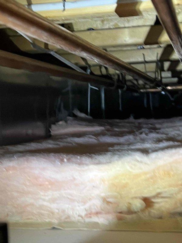 Responded to report of dripping water from HVAC furnace line in basement ceiling. Upon inspection, accessed crawl space above basement and located source of water leak at condensate drain line connection near five-year-old furnace system. Examined PVC condensate piping, drain trap, and associated connections throughout attic space. Identified loose fitting at condensate line junction causing intermittent dripping. Tightened connection, verified proper drain line pitch and trap function. Inspected insulation for water damage and confirmed no secondary leaks present. Tested system operation and monitored condensate flow to ensure proper drainage with no further leaking. Photographed affected area and repair for documentation purposes.
