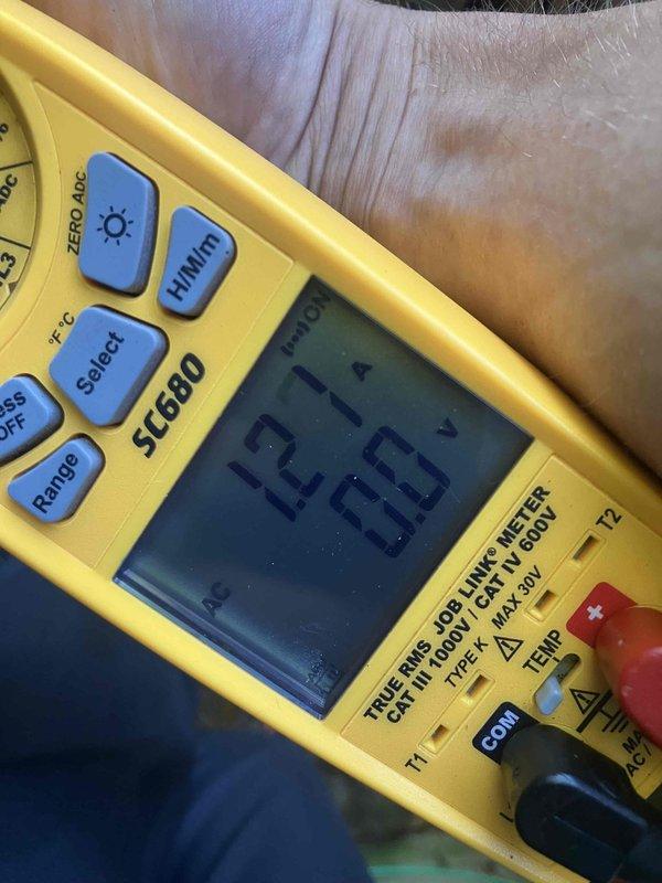 Responded to service call for loud rattling and banging noise from 3-month-old AC unit located in basement. Upon arrival, performed diagnostic inspection of outdoor condenser unit and tested electrical components using digital multimeter. Inspected fan assembly, motor mounts, and securing hardware on top discharge grille. Checked compressor operation and verified proper voltage readings. Given the age of equipment, confirmed unit is still under manufacturer warranty coverage. Tightened loose fan guard mounting screws and verified secure installation of all external components. Cycled unit through complete operation to confirm noise elimination and proper system function.