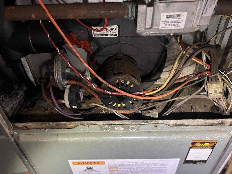 Responded to no-cooling call on five-year-old air conditioning system located in backyard. Performed diagnostic inspection of outdoor condensing unit and indoor air handler components, including examination of blower assembly, electrical connections, and control wiring. Documented equipment condition with photographs showing internal cabinet components, blower motor housing, and exterior utility connections for service records.