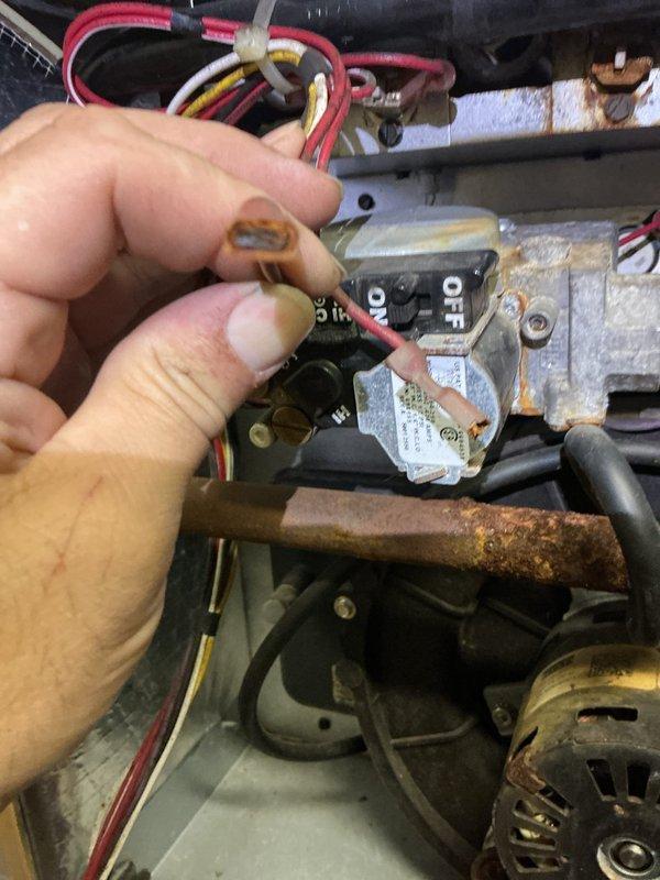 Responded to service call for AC blower malfunction on 10-year-old basement unit with additional furnace inspection requested. Upon inspection, discovered corroded electrical connections at blower motor circuit, evidenced by brown and orange oxidation on wire connectors affecting system operation. Identified failed door switch and rollout switches requiring replacement; parts ordered from Johnstone Roseville and are currently available for pickup. Documented deteriorated wiring connections and accumulated debris within unit compartment. System requires parts installation to restore full operational safety and functionality.