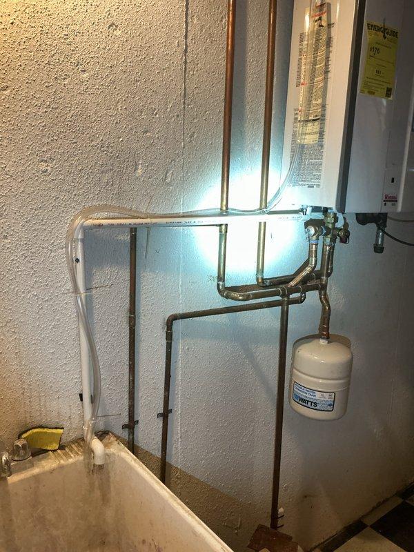 Completed plumbing estimate for gas line installation to convert existing wood-burning fireplace to gas operation in family room. Assessed routing from existing household gas service to fireplace hearth location, documented current gas infrastructure including water heater and utility connections in basement area, and evaluated access path through floor joists and ductwork for new copper gas line installation.