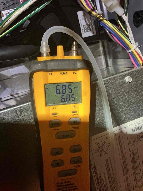 Completed comprehensive Gold Furnace Inspection on 4-year-old heating system located in basement. Performed full diagnostic evaluation including combustion analysis with digital manometer, recording gas pressure readings of 6.85 and 8.85 to verify proper manifold and inlet pressures. Conducted visual inspection of all system components including heat exchanger, blower assembly, electrical connections, and ductwork. Verified proper operation of all safety controls and limit switches. Checked and documented condition of wiring harnesses and electrical connections throughout cabinet. Inspected vertical supply plenums and ductwork connections for proper sealing and insulation. All components found operating within manufacturer specifications with no immediate concerns identified. System performing efficiently with no issues detected during inspection cycle. Also investigated reported water puddles in utility room near sump pump area; sump pump basin confirmed dry with no active water prese