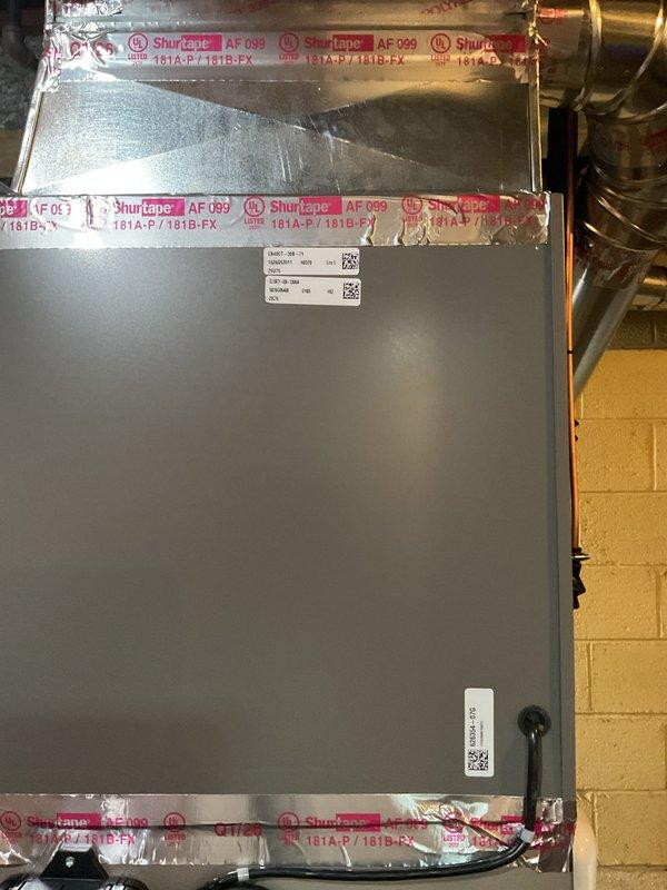 Completed installation of 2.5-ton air conditioning unit with matching evaporator coil in mechanical room. System was properly mounted, sealed with professional-grade foil tape, and connected to existing copper refrigerant lines and electrical supply. All components were labeled, tested for proper operation, and humidifier was reconnected to complete the HVAC system upgrade.