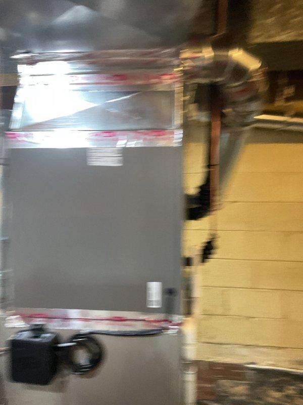 Completed installation of 2.5-ton air conditioning unit with matching evaporator coil in mechanical room. System was properly mounted, sealed with professional-grade foil tape, and connected to existing copper refrigerant lines and electrical supply. All components were labeled, tested for proper operation, and humidifier was reconnected to complete the HVAC system upgrade.