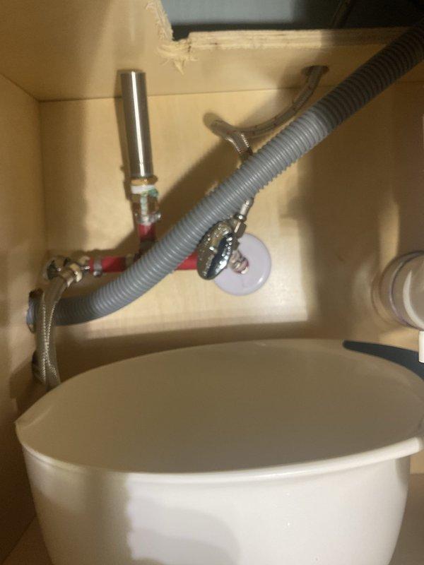 Responded to service call for faucet replacement and minor leak beneath bathroom sink. Upon inspection, identified leak originating from deteriorated supply line connections. Successfully replaced existing faucet assembly with new fixture, installed new braided stainless steel supply lines to both hot and cold water connections, and verified proper sealing at all connection points. Tested water flow and pressure at faucet, confirmed garbage disposal unit remained properly connected and functional, and inspected all under-sink plumbing for additional leaks. All connections secured and leak resolved.