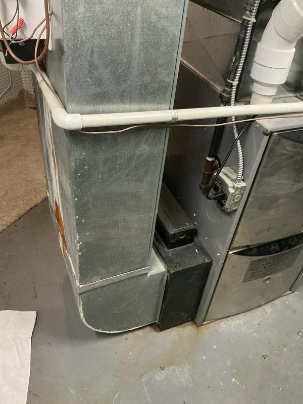 Responded to water leak concern near furnace with system remaining operational for heating and cooling. Inspected HVAC installation including furnace unit, air handler, condensate drainage system, and associated PVC piping. Customer reported recurring puddle formation every few days that would dry out and reappear, suspecting condensate line blockage. Evaluated condensate drain lines, trap assembly, and drainage pathways to identify source of intermittent water accumulation. Cleared obstruction from condensation pipes to restore proper drainage flow and prevent future pooling at equipment base.