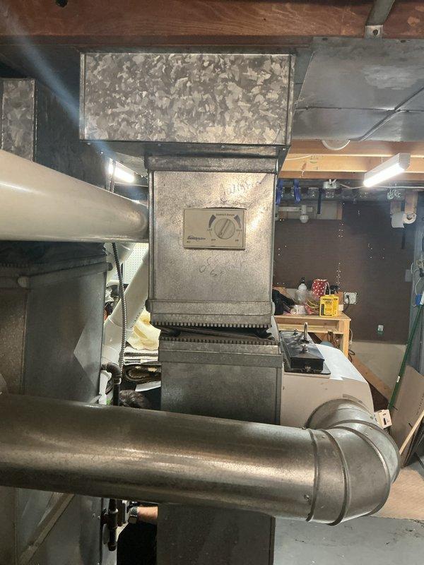 Responded to water leak concern near furnace with system remaining operational for heating and cooling. Inspected HVAC installation including furnace unit, air handler, condensate drainage system, and associated PVC piping. Customer reported recurring puddle formation every few days that would dry out and reappear, suspecting condensate line blockage. Evaluated condensate drain lines, trap assembly, and drainage pathways to identify source of intermittent water accumulation. Cleared obstruction from condensation pipes to restore proper drainage flow and prevent future pooling at equipment base.