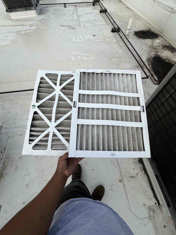 Completed scheduled filter change maintenance on two rooftop units at commercial facility. Accessed roof-mounted RTUs and removed existing filters showing moderate dust accumulation and discoloration from normal operation. Installed new replacement filters in both units to restore proper airflow and system efficiency. All units operational upon completion with improved air filtration performance.