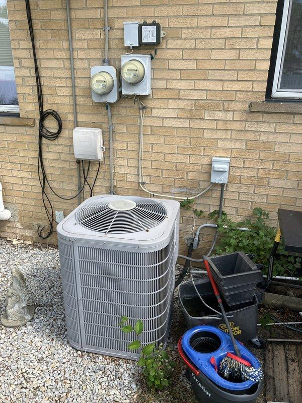 Conducted comprehensive assessment of existing 13-year-old air conditioning and furnace systems located in basement for full replacement estimate. Inspected outdoor condensing unit, electrical service panel, and metering equipment to evaluate current installation configuration and determine replacement requirements. Documented existing equipment specifications, electrical infrastructure, and site conditions through detailed photography to develop accurate replacement proposal for aging HVAC systems.