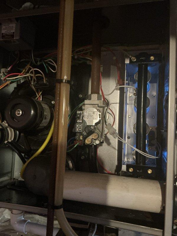 Completed comprehensive Gold-level furnace inspection on forced-air heating system located in crawl space. Performed thorough examination of all major components including blower motor assembly, gas valve controls, burner chamber, and ignition system. Verified proper operation of all electrical connections, wiring harnesses, and safety controls. Inspected heat exchanger for cracks or deterioration, examined burner flames for proper combustion characteristics, and confirmed gas valve functionality with visible ON/OFF indicators operating correctly. Tested blower motor performance and checked all wire connections for secure termination. Utilized digital combustion analyzer to measure and document system performance parameters including temperature readings and combustion efficiency. Documented equipment condition through photographic records showing internal components, control systems, and blue-flame burner assembly. All components found operating within manufacturer specifications with