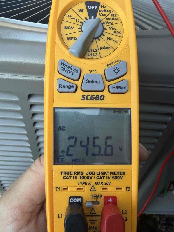 Responded to service call for 1.5-year-old AC unit in basement producing loud banging noises. Diagnosed failed condenser fan motor through visual inspection and electrical testing using digital multimeter, which confirmed abnormal voltage readings of 245.6V AC and 40.43 (secondary measurement). Ordered replacement condenser fan and motor assembly from Lennox under warranty coverage (PO #1370659-001), with parts available for pickup at parts house. Unit temporarily shut down to prevent further damage until replacement components arrive and installation can be completed.