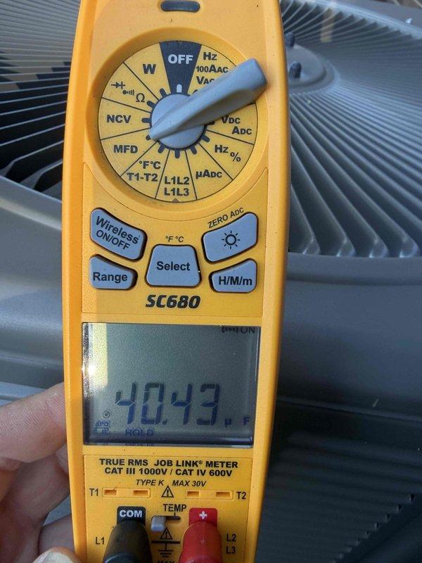 Responded to service call for 1.5-year-old AC unit in basement producing loud banging noises. Diagnosed failed condenser fan motor through visual inspection and electrical testing using digital multimeter, which confirmed abnormal voltage readings of 245.6V AC and 40.43 (secondary measurement). Ordered replacement condenser fan and motor assembly from Lennox under warranty coverage (PO #1370659-001), with parts available for pickup at parts house. Unit temporarily shut down to prevent further damage until replacement components arrive and installation can be completed.