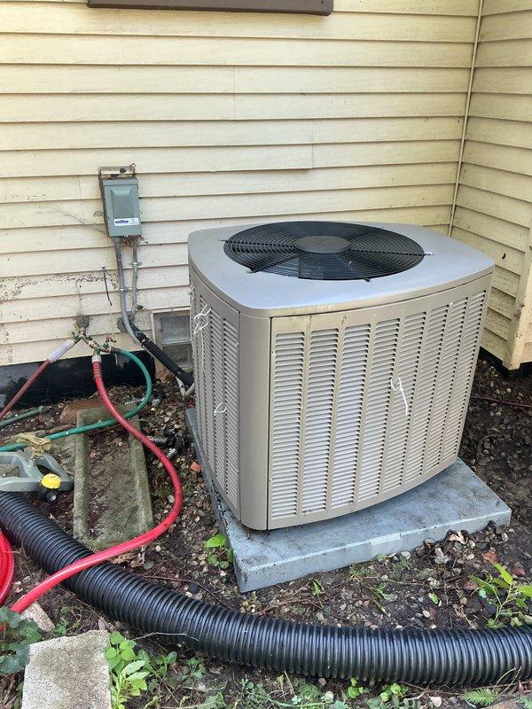Completed comprehensive Gold Furnace Inspection on residential HVAC system including 2018 furnace with coil located in basement and 5-year-old outdoor air conditioning unit. Performed thorough examination of furnace internal components including gas valve assembly, burner operation, heat exchanger condition, blower motor function, and electrical connections. Inspected multicolored control wiring, copper refrigerant lines, and condensate drainage system. Verified proper combustion and air flow through viewing window. Evaluated outdoor condensing unit positioned on concrete pad, checking condenser coil condition, fan motor operation, electrical disconnect, and refrigerant line connections. Documented equipment condition through photographs showing internal furnace components and external AC unit installation. All systems operational and functioning within normal parameters. Maintenance completed per Gold service plan specifications.