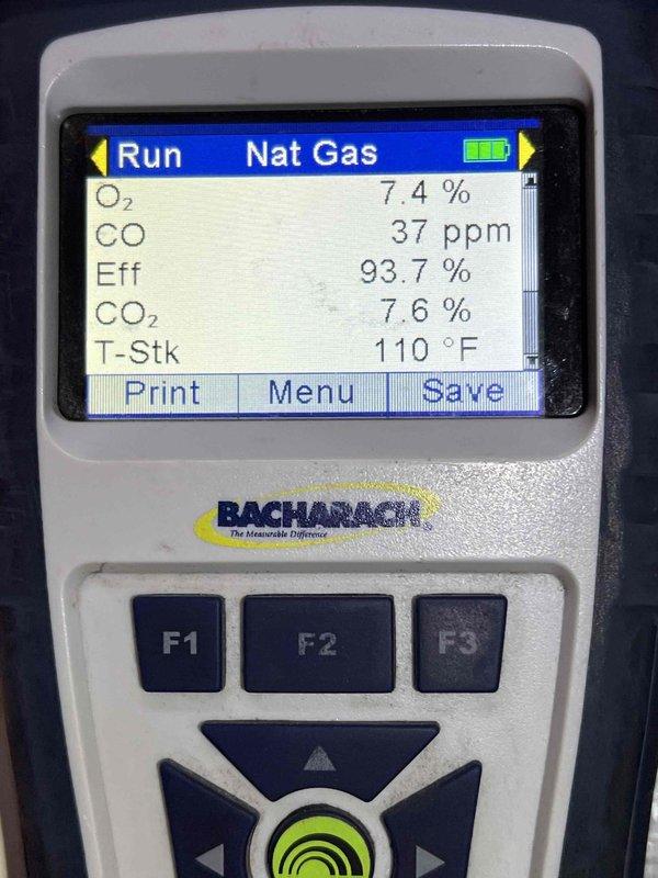 Completed comprehensive furnace inspection and tune-up on a 12-15 year old Bryant forced air system located in basement. Performed combustion analysis using Bacharach analyzer, which confirmed optimal performance with 93.7% efficiency, 37 ppm CO, 7.4% O2, 7.6% CO2, and 110°F stack temperature. Inspected blower motor assembly, electrical connections, and internal components; all found to be in proper working condition with no immediate repairs needed.