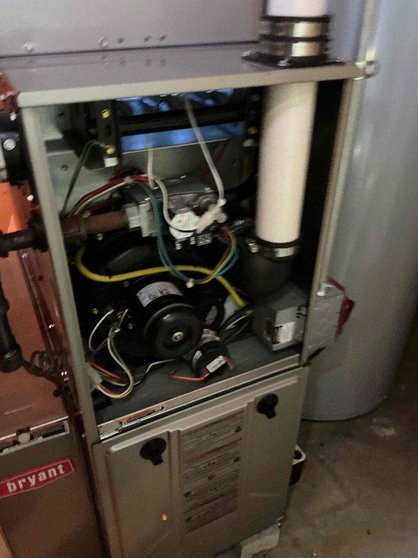Completed comprehensive furnace inspection and tune-up on a 12-15 year old Bryant forced air system located in basement. Performed combustion analysis using Bacharach analyzer, which confirmed optimal performance with 93.7% efficiency, 37 ppm CO, 7.4% O2, 7.6% CO2, and 110°F stack temperature. Inspected blower motor assembly, electrical connections, and internal components; all found to be in proper working condition with no immediate repairs needed.