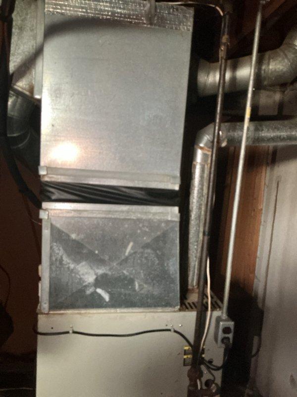 Completed estimate for replacement of 1998 AC condenser system serving basement-located equipment with natural gas furnace. Existing unit running but failing to provide adequate cooling capacity, requiring full system replacement evaluation. Documented existing ductwork configuration, plenum assembly, and mechanical infrastructure to determine proper replacement specifications.
