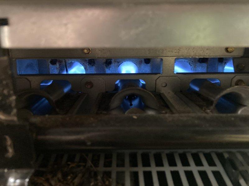 Completed comprehensive Gold Furnace Inspection on a 5-year-old forced air heating system located in basement. Performed inspection protocol on three furnace units and one boiler system. Verified operational status of all equipment, observed proper burner ignition and flame characteristics with blue flames indicating optimal combustion and correct air-fuel mixture. Documented active operation of burner assembly with photographic evidence showing proper flame pattern across all burner ports. Confirmed heat exchanger condition and verified proper burner positioning per manufacturer specifications. All units found operational at time of inspection.