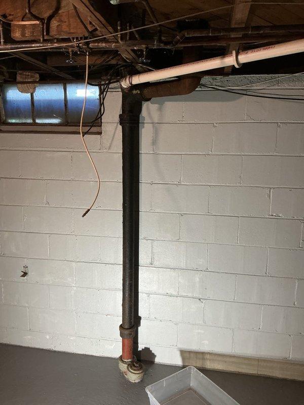 Responded to basement water leak originating from toilet fixture. Conducted comprehensive inspection of plumbing systems including toilet connection points, dishwasher supply and drain lines, and bathtub drainage assembly. Identified corroded pipe fitting at basement stack connection with visible rust deterioration and active moisture presence. Documented mechanical compartment components and basement plumbing infrastructure. Provided detailed quote for leak repair and recommended addressing corroded fittings to prevent further water damage.