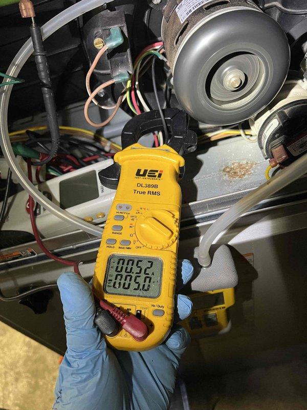 Completed comprehensive Gold-level furnace inspection on 11-year-old forced air system located in basement. Performed diagnostic testing using digital multimeter to verify electrical parameters and motor performance, confirming proper voltage and amperage readings on blower motor assembly. Inspected all electrical connections, wiring integrity, and motor components; verified system operational status and documented equipment condition with no deficiencies found requiring immediate attention.