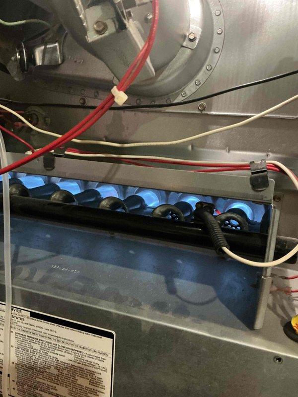 Completed comprehensive gold-level tune-up and inspection on 10-year-old gas furnace and air conditioning system located in basement. Performed thorough examination of furnace burner assembly, confirmed proper blue flame combustion pattern, inspected blower motor housing and electrical connections, and verified all wiring integrity. Inspected outdoor condenser unit including fan assembly, protective grill guard, and motor operation. All components found operating within normal parameters with no immediate service needs identified at this time.