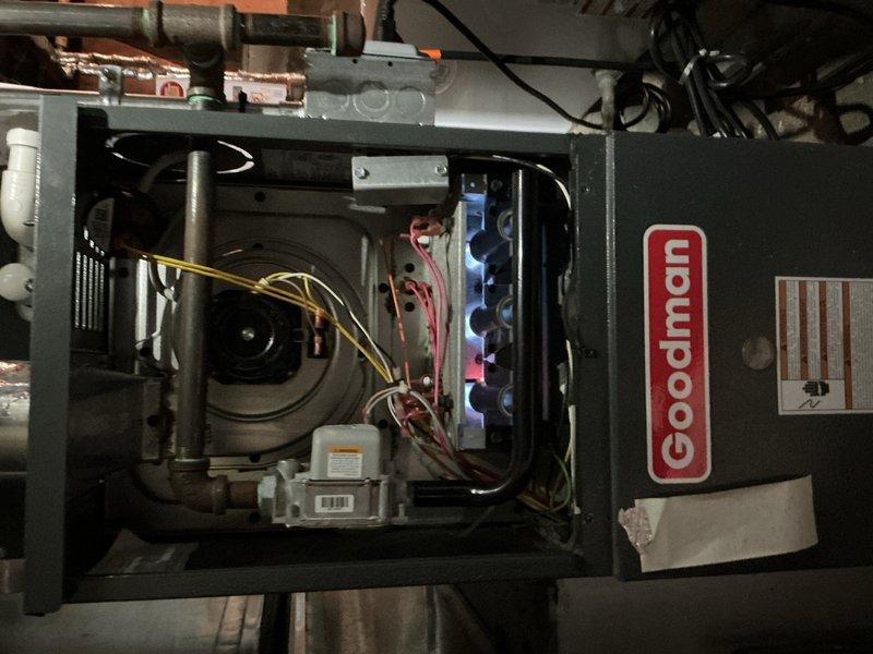 Completed comprehensive Gold-level furnace inspection on a 1-year-old Goodman forced-air heating system located in basement. Performed thorough visual examination of all accessible components including blower motor assembly, electrical connections, and internal mechanical systems. Inspected copper piping, valve assemblies, and ductwork connections for proper operation and signs of wear. All components found to be in good working condition with no immediate service needs identified. Unit operating within normal parameters.