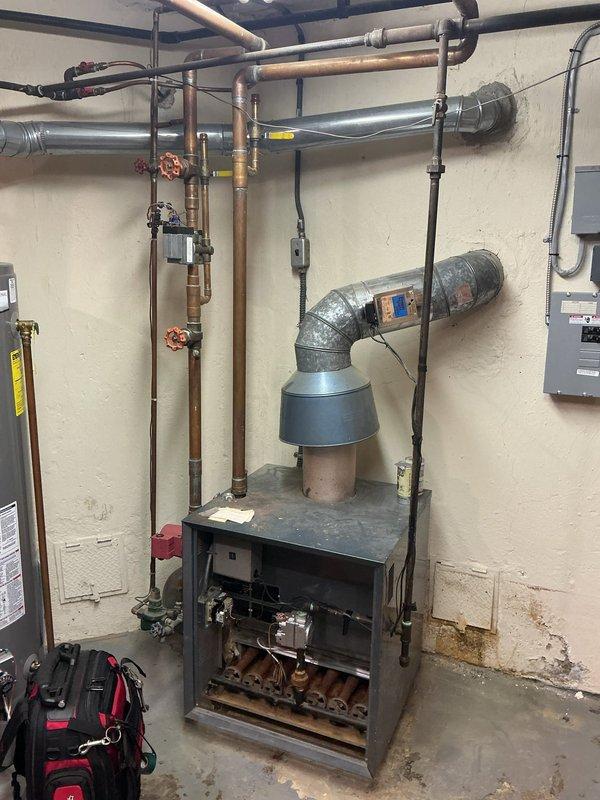 Completed comprehensive Gold-level furnace maintenance inspection on residential heating system located in basement. Performed full system evaluation including blower assembly inspection, heat exchanger examination, electrical connections verification, and combustion analysis. Installed Sensi thermostat as requested during service visit. All components found operating within normal parameters, with blower wheel and internal mechanisms showing typical operational wear. System tested and confirmed functioning properly upon completion.