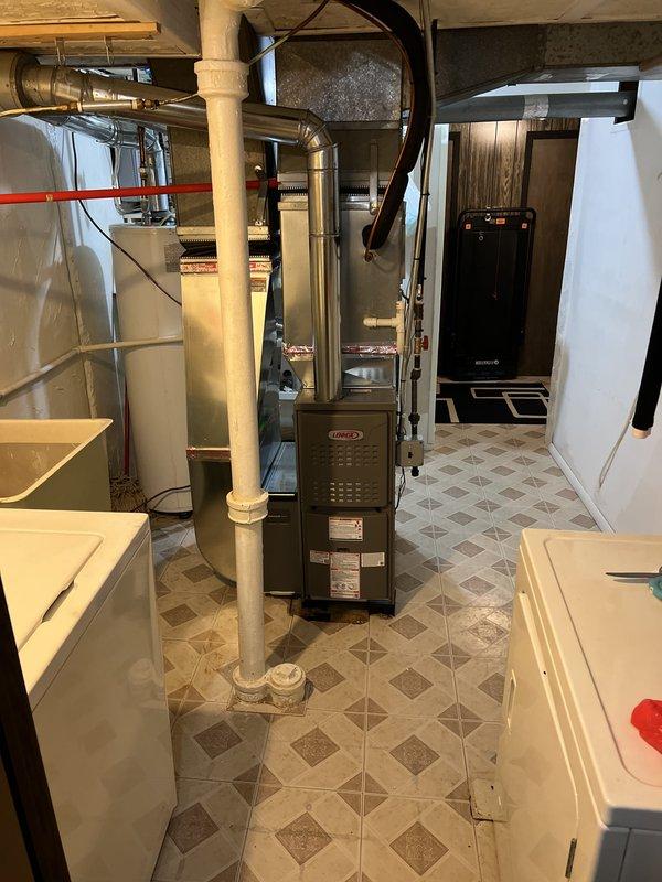Completed installation of new Lennox furnace system in basement utility area, including new thermostat and all associated ductwork connections. Permit was requested and financing approved prior to installation, with all work performed to manufacturer specifications and local code requirements.