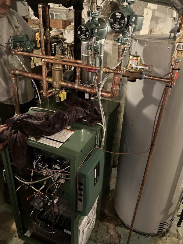 Completed full boiler installation including new boiler unit, three thermostats, three circulation pumps, and system controller. Installed complete copper piping network with flow meters, valves, and necessary connections to integrate boiler with existing water heater system. Mechanical-only installation performed with permit requested; electrical reconnection completed by licensed electrician.