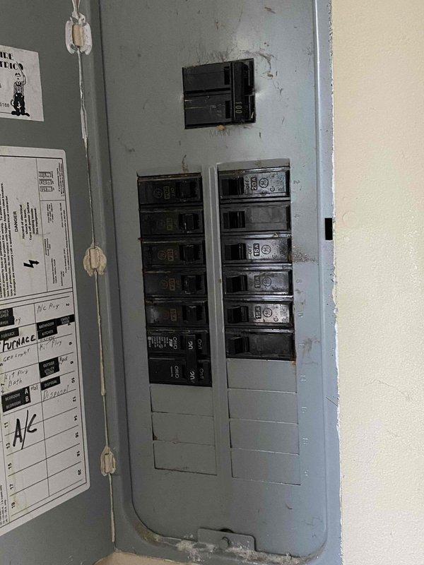 Responded to service call for 15-year-old air conditioning system located in attic that was not operational. Performed comprehensive system evaluation and documented existing electrical infrastructure including main breaker panel, circuit directory, and exterior meter installation. Provided replacement estimate for complete HVAC system due to age and non-functional status of equipment.