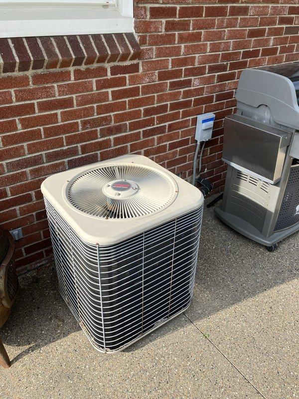 Completed comprehensive full system HVAC estimate for residential property with existing Lennox air conditioning condenser unit installed on exterior brick wall. Documented current equipment condition, photographed installation site including outdoor unit placement and surrounding area, and assessed system requirements for potential replacement or upgrade recommendations.