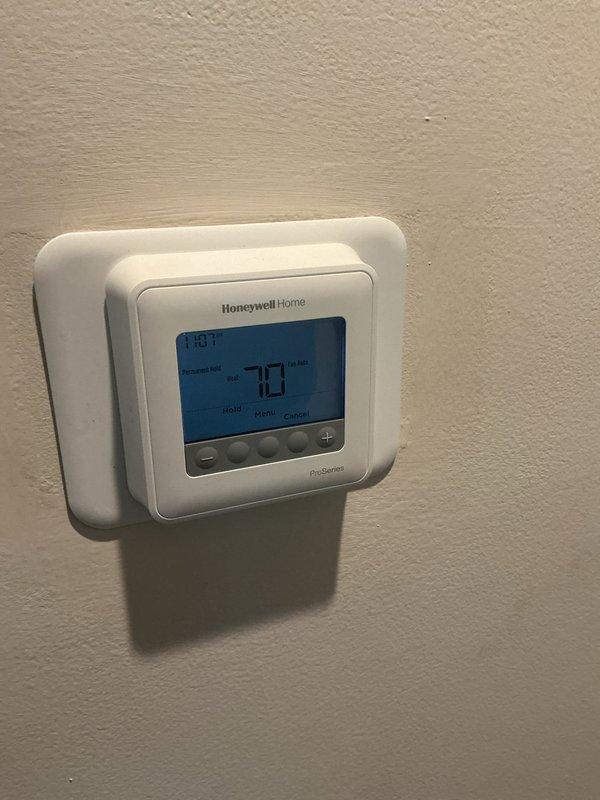 Completed comprehensive Gold-level furnace inspection on 2-year-old heating system located in basement mechanical room. Performed thorough visual examination of furnace components, verified thermostat operation and programming settings, inspected heat exchanger for cracks or deterioration, checked all electrical connections and safety controls, tested ignition system and burner assembly, examined venting and flue pipe for proper installation and clearances, verified adequate combustion air supply, and inspected gas line connections for leaks. Thermostat displaying proper temperature readings and functioning correctly in program hold mode. All furnace components operating within manufacturer specifications with no immediate safety concerns identified. System ready for heating season operation.