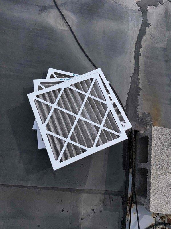 Completed scheduled filter change on commercial rooftop unit requiring lift access. Replaced three pleated air filters and documented significant rust deterioration on interior access panel and equipment housing, indicating potential moisture intrusion that may require future attention. Unit operational upon completion with improved airflow following filter replacement.