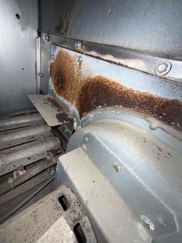 Completed scheduled filter change on commercial rooftop unit requiring lift access. Replaced three pleated air filters and documented significant rust deterioration on interior access panel and equipment housing, indicating potential moisture intrusion that may require future attention. Unit operational upon completion with improved airflow following filter replacement.