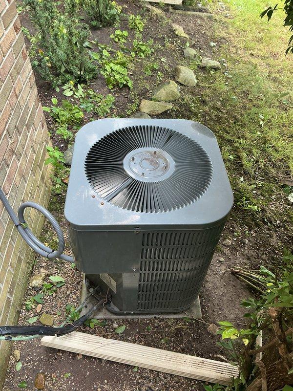 Completed comprehensive Gold AC Inspection on 13-year-old air conditioning system located in basement. Performed full system tune-up including inspection of outdoor condenser unit positioned on concrete pad adjacent to building exterior, verified proper operation of condenser fan and examined ventilation components. Inspected evaporator coil and honeycomb mesh filter media within air handler, noting mineral deposit accumulation on filter surface consistent with normal operation over service interval. Checked refrigerant lines, electrical connections, and condensate drainage system. Confirmed last service was performed approximately six months prior as requested. All components operating within normal parameters with no immediate repairs required. System cooling efficiently with no reported performance issues. Recommended continued routine maintenance schedule to ensure optimal performance and longevity of aging equipment.